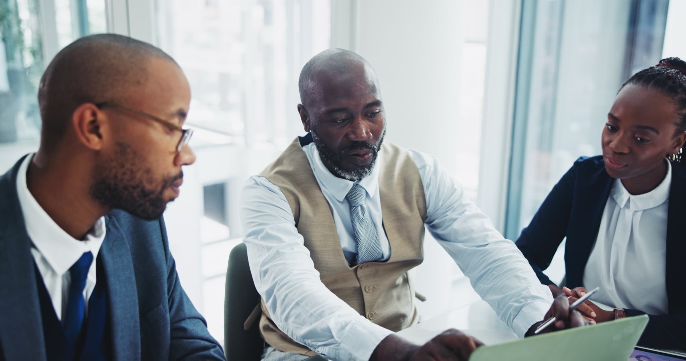 Colleagues reviewing benefit paperwork together